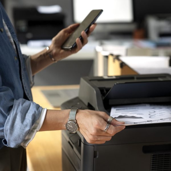 side-view-worker-holding-smartphone